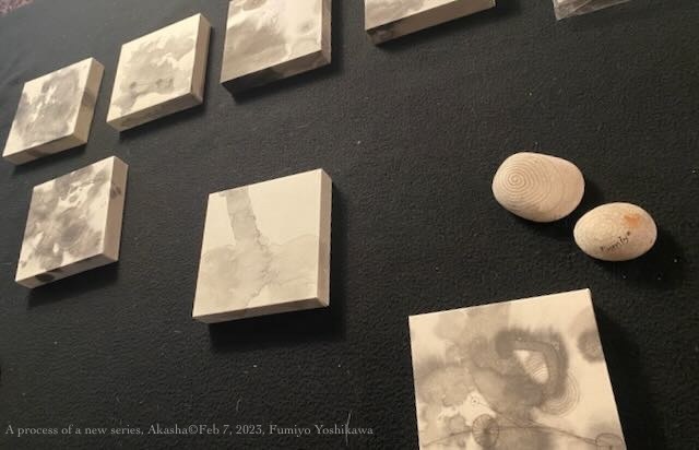 A process of the Akasha series — small panels in progress laid out on black cloth, studio, 2023